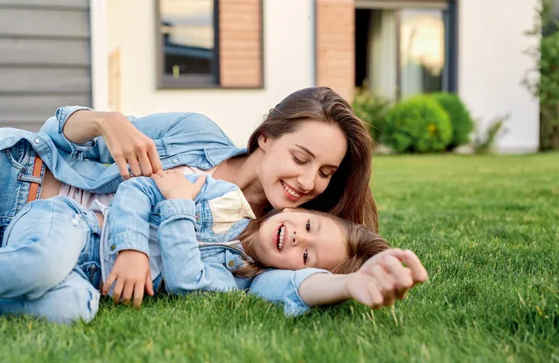 mother and daughter playing outside mosquito free lawn