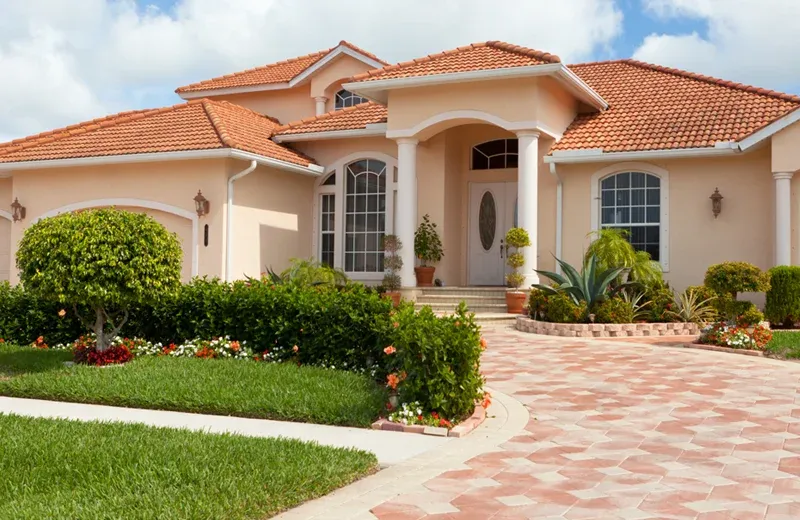 Florida home with healthy trees and shrubs in front yard